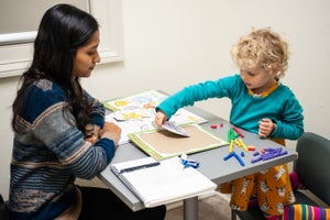 Student playing with a kid